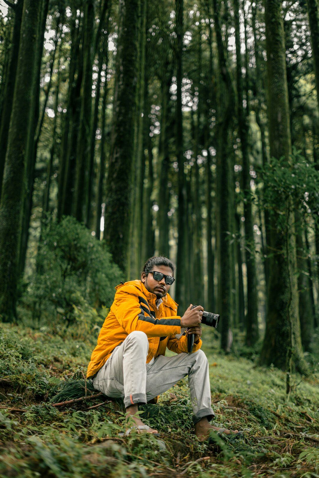 Photographer crouching to take a photo outdoors