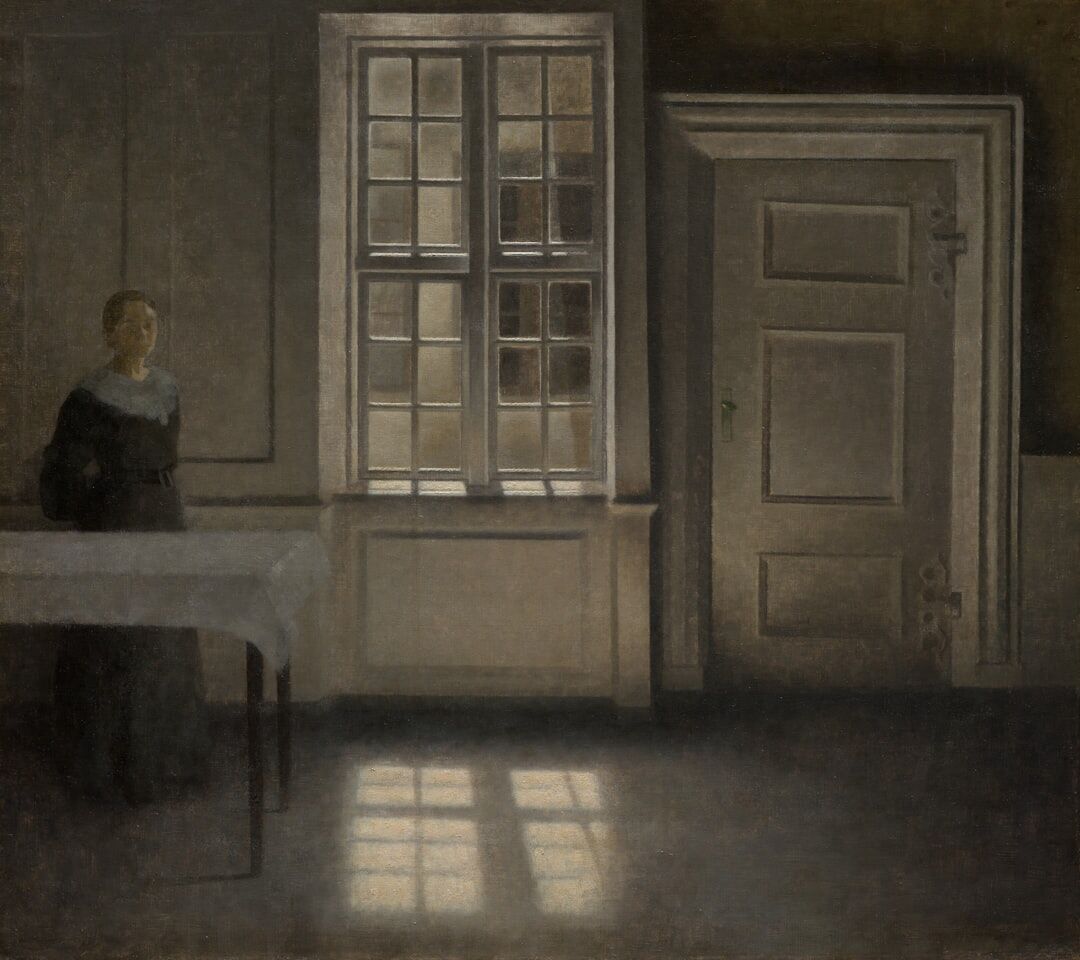 Portrait of an elderly Danish woman knitting by a window